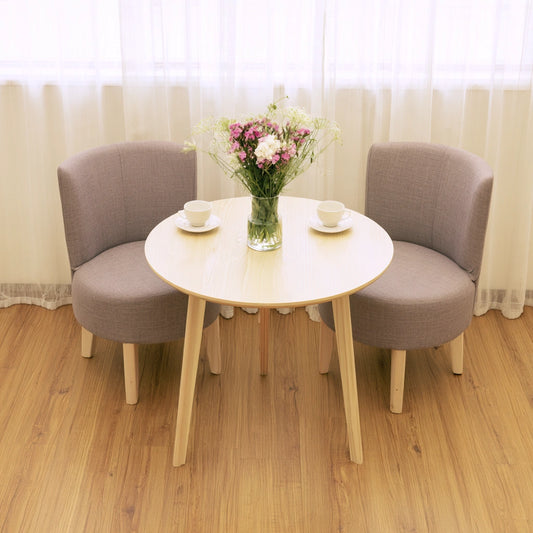 Light brown round wooden side table from Zenoakstudio, ideal for living room or cozy seating areas.