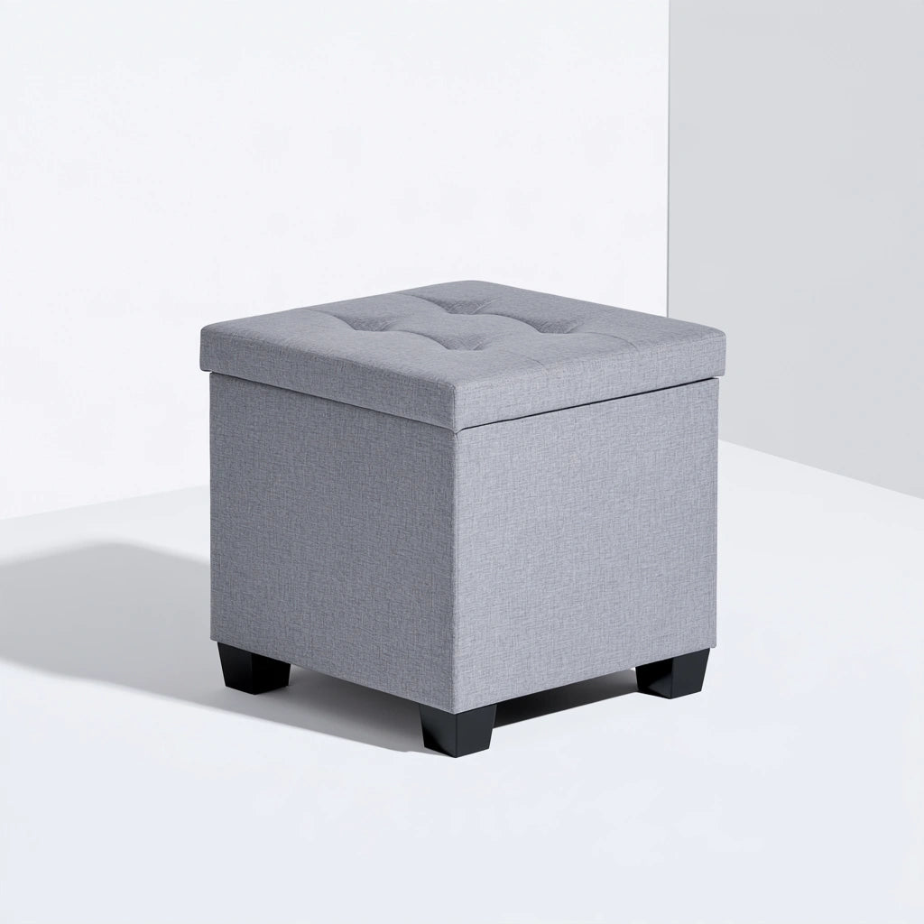 Gray cube-shaped storage pouf by Zenoakstudio, versatile ottoman for living room or home decor, with a soft fabric surface.