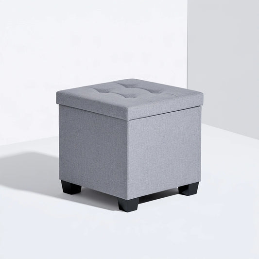 Gray cube-shaped storage pouf by Zenoakstudio, versatile ottoman for living room or home decor, with a soft fabric surface.