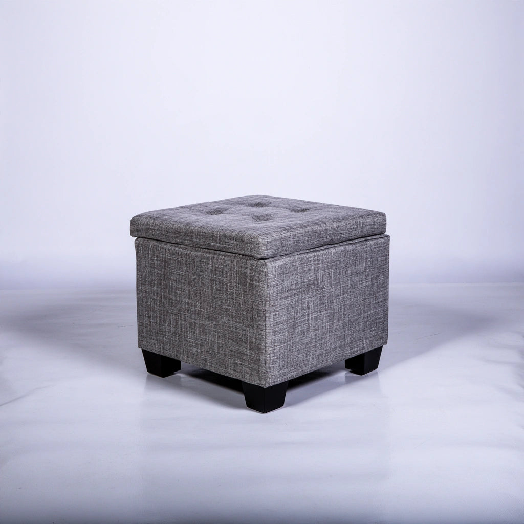 Gray cube-shaped storage pouf by Zenoakstudio, versatile ottoman perfect for living room decor and extra seating.
