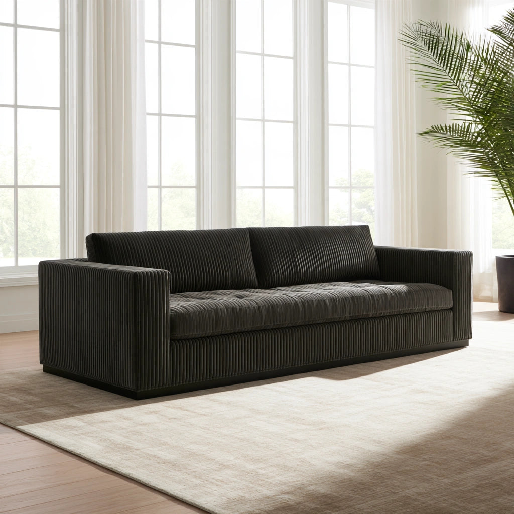 Dark gray velvet two-seater sofa with vertical ribbing, modern design, ideal for living room decor, by Zenoakstudio.