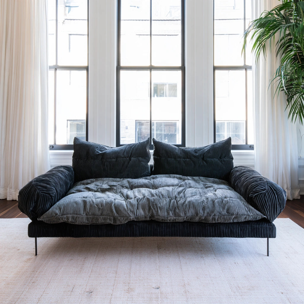 Dark gray velvet two-seater sofa with vertical ribbing, designed for living room comfort by Zenoakstudio.