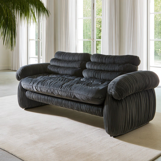 Dark gray velvet two-seater sofa with vertical ribbing, modern design, suitable for living room by Zenoakstudio.