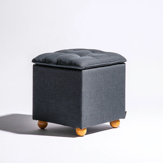Dark grey fabric square pouf by Zenoakstudio, modern ottoman suitable for living room decor and seating.